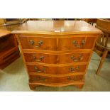 A yew wood serpentine chest of drawers