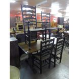 An oak refectory table and four ladderback chairs