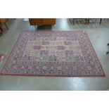 A red ground rug, 227 x 170cms