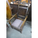 An Arts and Crafts oak reclining armchair