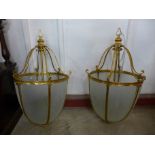 A pair of large French style gilt metal and glass panelled ceiling lights