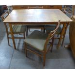 A Meredew teak extending dining table and four chairs