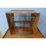 A mahogany counter top display cabinet, bearing Cadbury's inscription