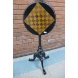 A Victorian Aesthetic Movement ebonised circular tilt-top games table