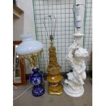 A figural cherub table lamp and two others