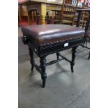 A Victorian ebonised adjustable piano stool