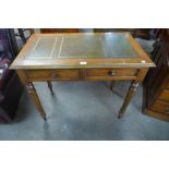 A Victorian oak and leather topped two drawer writing table