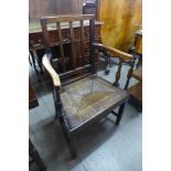A George III elm rush seated elbow chair