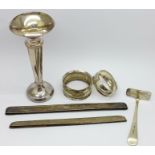 A silver posy vase, (weighted), two silver napkin rings, a silver pusher and two silver comb