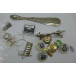A silver handled shoe horn, Birmingham 1904, a silver toe ring, other silver, regimental badges,