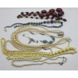 Vintage jewellery including faux pearl necklaces, two with silver clasps and a sherry amber