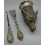 A silver handled shoe horn and button hook and a plated fox head stirrup cup