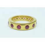 A silver gilt and ruby eternity ring, M