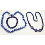 A lapis lazuli necklace and bracelet, and one other blue bead necklace