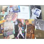 A collection of Queen memorabilia, including concert programmes and fan club literature