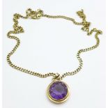 A 9ct gold and purple stone pendant on a 9ct gold chain, total weight 16.5g