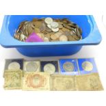 A collection of coins and a few banknotes