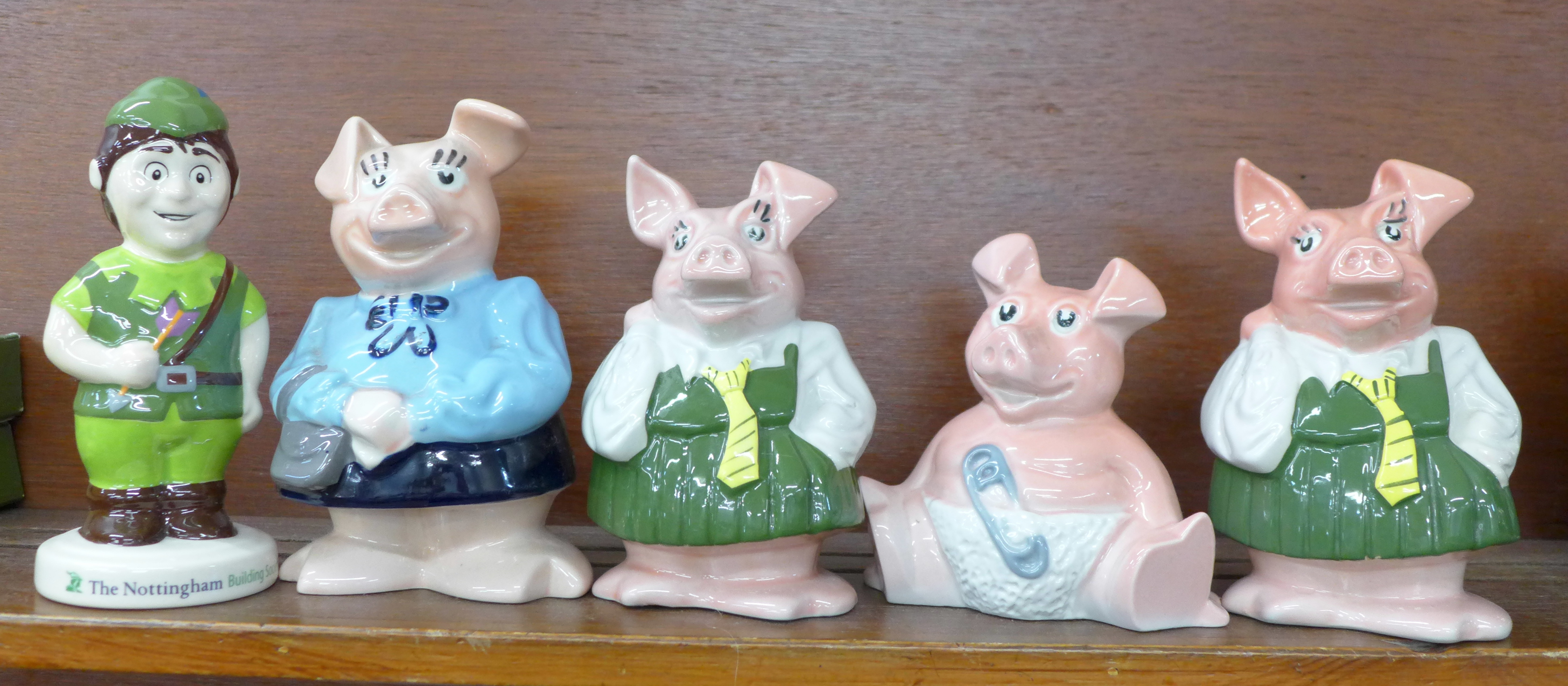 Four Wade Nat West pig money banks and a Nottingham Building Society Robin Hood money box, boxed