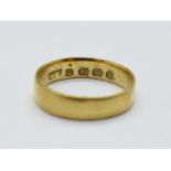 An 18ct gold wedding band, 1.8g, F