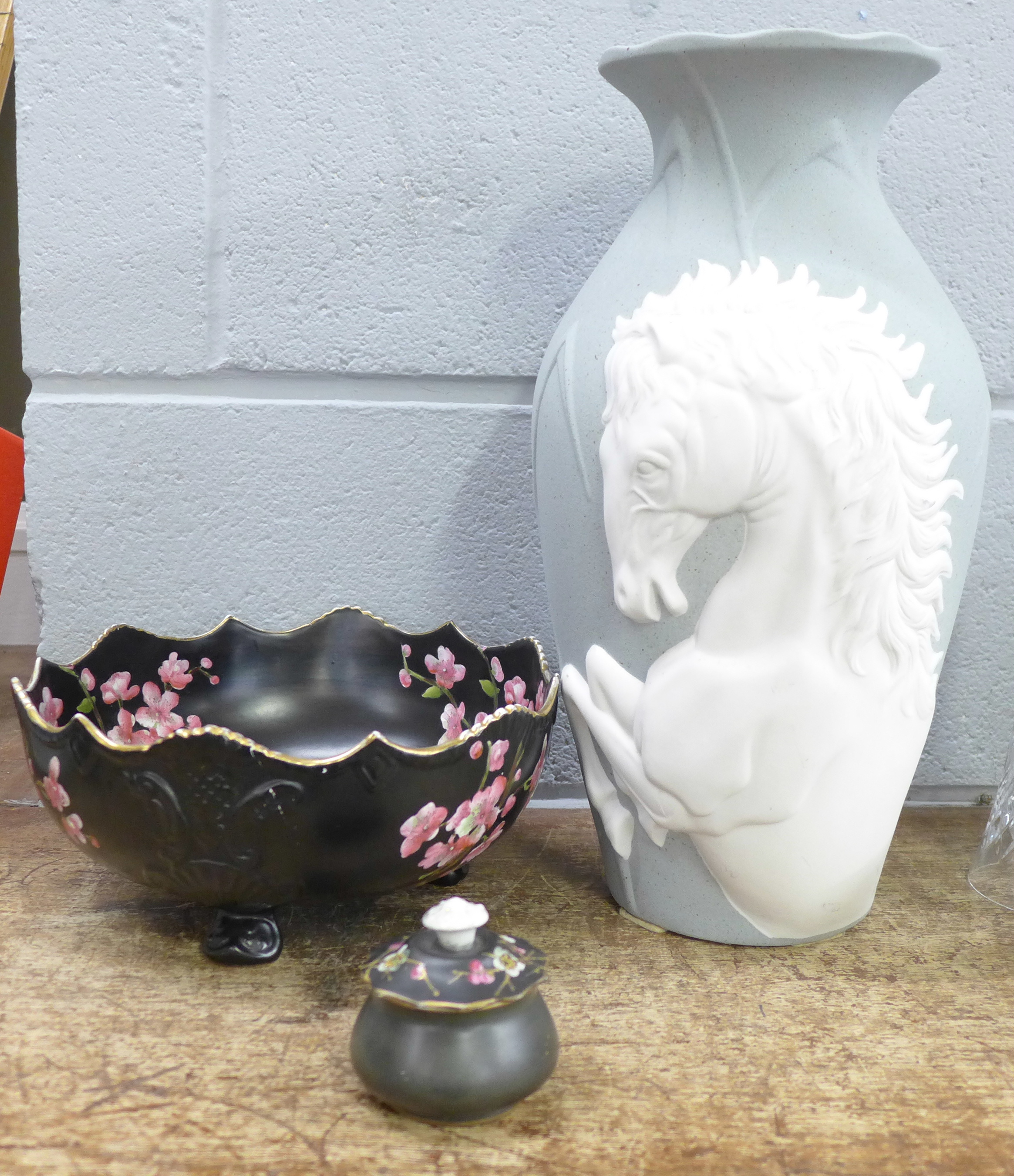 A tall vase with relief horse figure, a fruit bowl and a pot