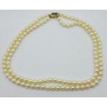 A double strand pearl necklace, with 14ct gold, sapphire and diamond clasp