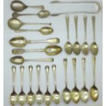 A collection of silver teaspoons, a silver caddy spoon and a pair of silver sugar bows, 330g