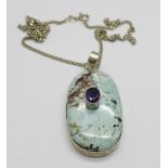 A large silver gem set pendant and chain