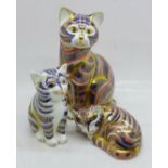 Three Royal Crown Derby cat paperweights, two with gold stoppers, one lacking stopper