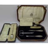 A silver mounted part manicure set, cased, and a silver spoon, cased