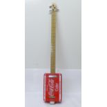 A novelty Coca-Cola guitar