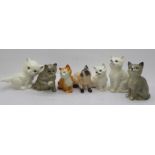 Seven cat figures, three Royal Doulton, two Beswick, one a/f, and two Goebel