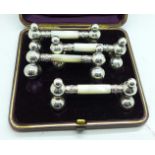 A cased set of four silver plate and mother of pearl knife rests