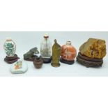 A collection of scent bottles including Chinese, wooden bases and an amber piece