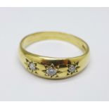 An 18ct gold, three stone diamond ring, 6.1g, X