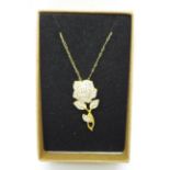 A silver gilt rose pendant with diamond accent