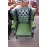 A beech and green leather Chesterfield wingback armchair