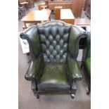 A beech and green leather Chesterfield wingback armchair