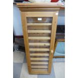 A small wall hanging pine display cabinet