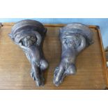 A pair of concrete cherub wall sconces