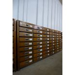 A Victorian oak museum cabinet, with six banks of nine drawers, 86cms h, 200cms w, 40cms d