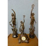 A pair of spelter figures and matching mantel clock