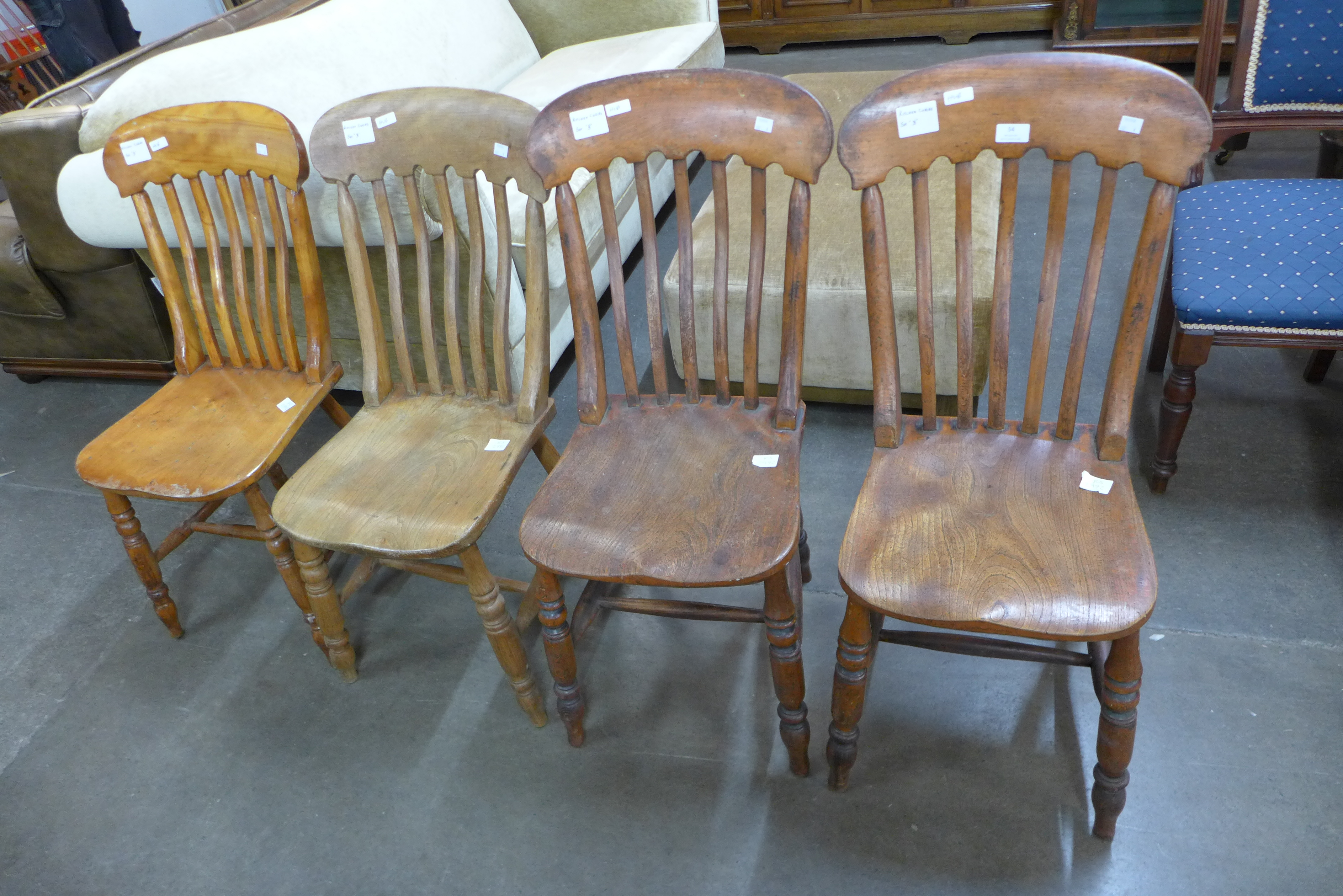 A Harlequin set of four Victorian elm and beech kitchen chairs