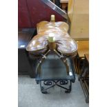 A leather topped beech camel stool and a wrought iron and glass topped occasional table