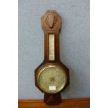 An Art Deco Bravingtons Ltd. carved oak aneroid barometer