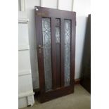 An oak and leaded glass door