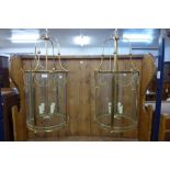 A pair of French style gilt metal cylindrical hanging ceiling lanterns