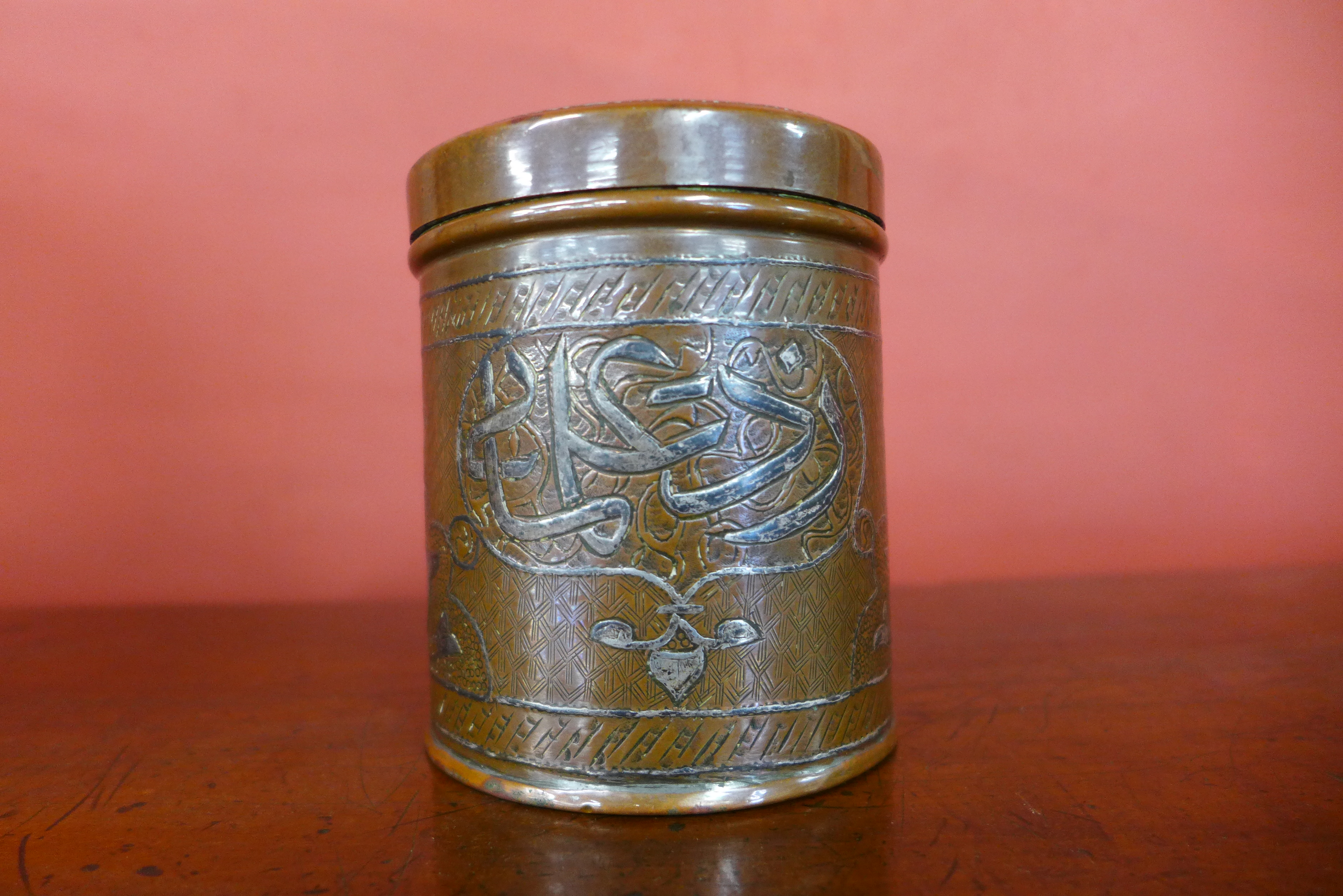 A late 19th/early 20th Century Islamic Mamluk revival silver inlaid copper jar and cover, 10cms h