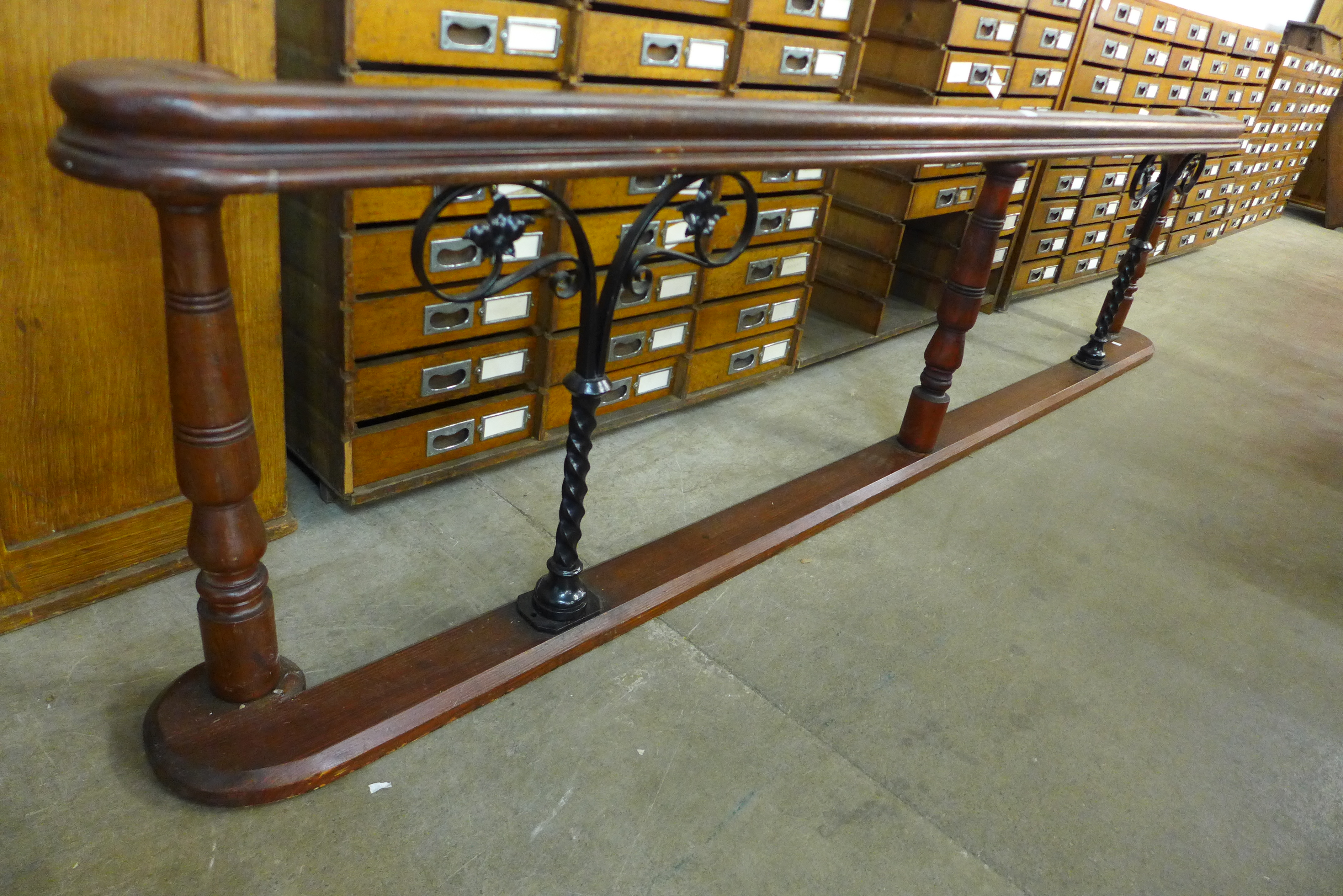 A stained pine and wrought iron altar rail