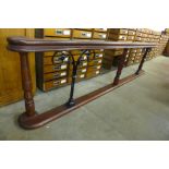 A stained pine and wrought iron altar rail