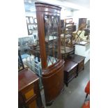 A mahogany freestanding corner cabinet